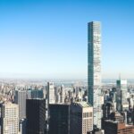 Stunning aerial view of New York City skyline featuring iconic skyscrapers under a clear sky.