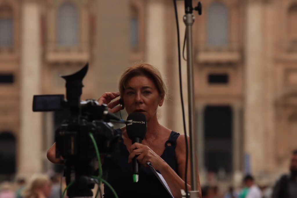 Journalist reporting live from Vatican City, capturing the essence of urban broadcast journalism.