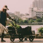 A hardworking woman cleaning the riverside in Bangkok, Thailand.