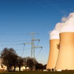A nuclear power plant in Hameln, Germany, showcasing cooling towers and electricity pylons.