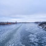 A stunning winter view of Stockholm cityscape with a frozen lake and urban landscape.