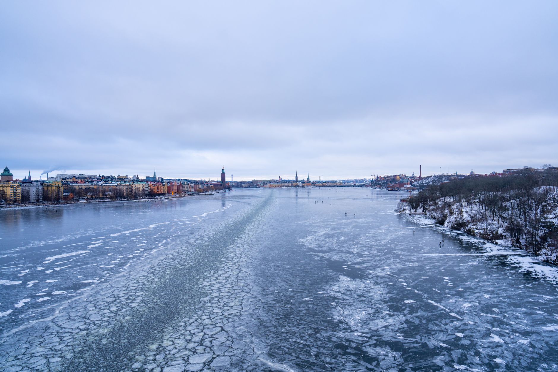 A stunning winter view of Stockholm cityscape with a frozen lake and urban landscape.