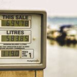Blurred background view with focus on fuel pump display showing price and liters.