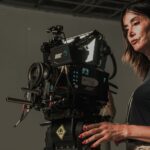 A female cinematographer operates a professional cinema camera on a film set in İstanbul, Türkiye.
