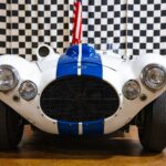 Front view of a classic Cunningham C-4R sports car at an exhibit in Philadelphia.