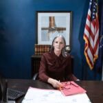 Professional woman in an office representing leadership and authority.