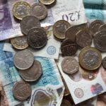 Close-up of British coins and banknotes, showcasing different denominations for financial concepts.