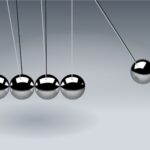 Dynamic illustration of Newton's Cradle showing motion and reflection concepts in physics.