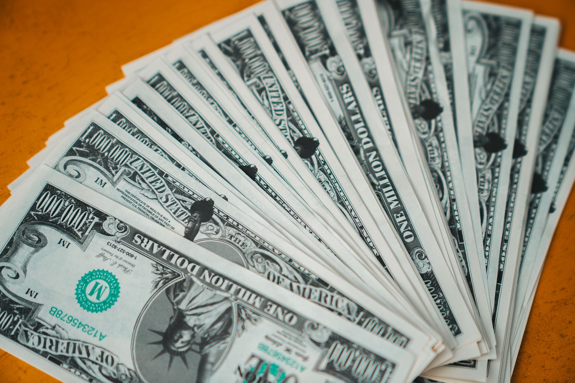 Closeup of novelty one million dollar bills laid out in a fan arrangement.