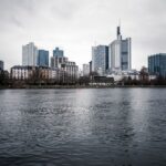 View of Frankfurt's skyline under an overcast sky across the river.