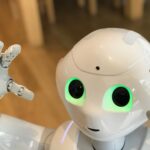 A futuristic humanoid robot with glowing green eyes in a modern setting.