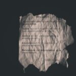 Calvin Coolidge quote on perseverance printed on crumpled paper.