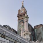 View of the iconic Abraj Al Bait and Mecca Clock Tower with surrounding architecture.