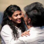 A joyful couple sharing an affectionate moment with smiles and warmth.