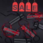 Elegant black gift boxes with red ribbons on sale promotion background.