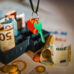 House key and euro bills depicting real estate and financial themes.