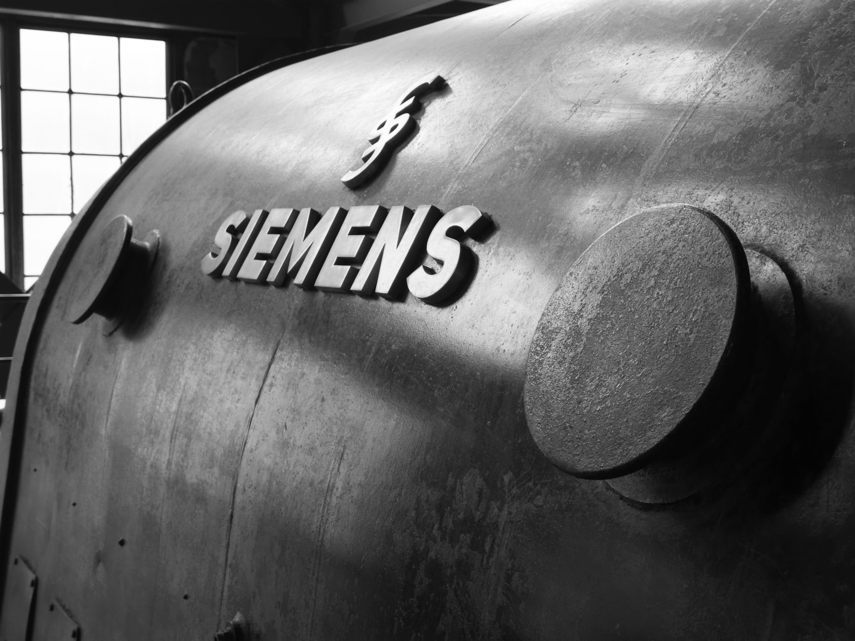 Black and white close-up of vintage Siemens machinery with industrial details.