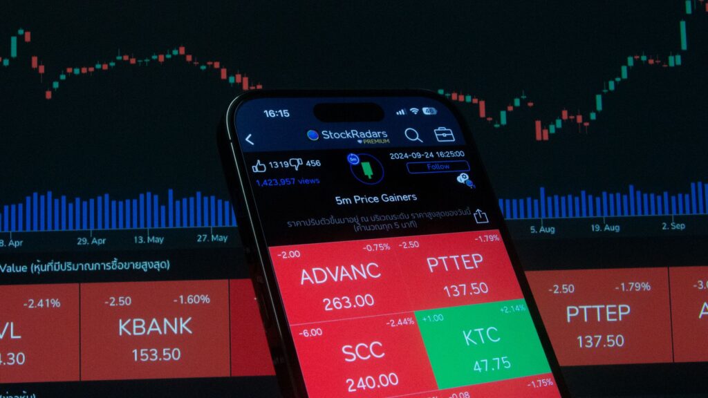 Mobile screen displaying stock market analysis with financial charts in the background.