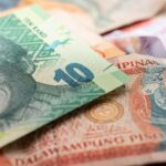 A detailed image featuring South African rand and Philippine pesos, highlighting cultural diversity in currency.