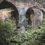 Explore the overgrown greenery and graffiti on this abandoned Canadian structure.