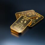 Close-up of gold bars on a dark background, representing wealth and investment opportunities.