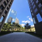 Modern skyscrapers framing the vibrant Houston skyline under a bright blue sky.