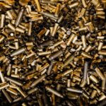 A detailed view of a pile of brass bullet casings, showcasing their metallic luster.