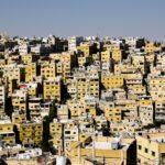 Aerial view capturing the densely packed urban buildings in Amman, Jordan, depicting a bustling cityscape.