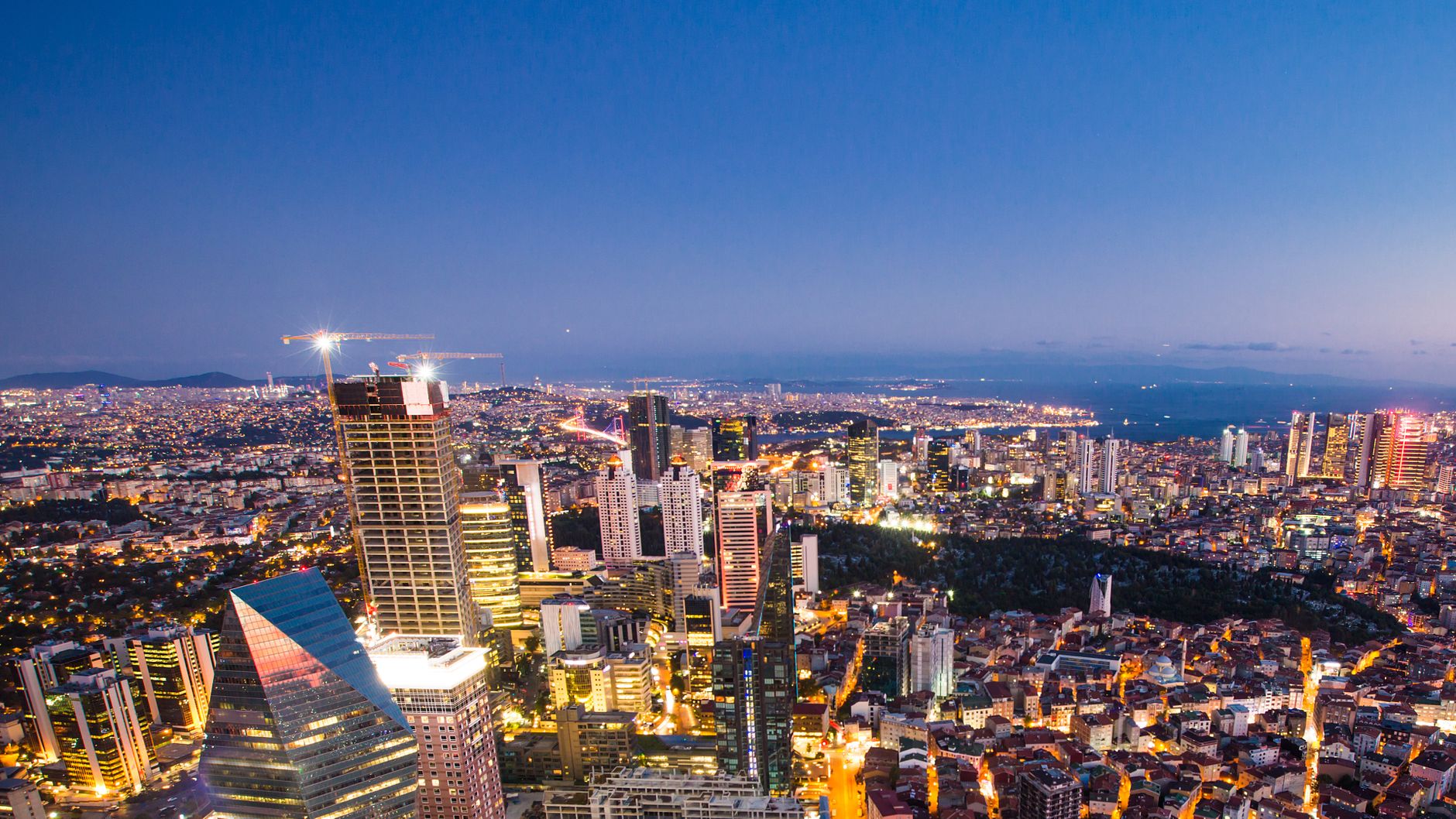 A breathtaking aerial view of Istanbul city lights at twilight, showcasing modern skyscrapers and vibrant skyline.