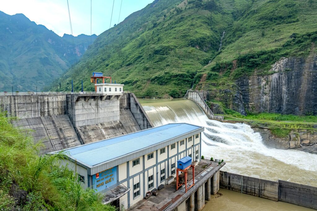 Hydroelectric dam set against lush green mountains, showcasing power generation.