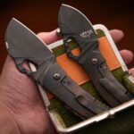 Close-up of compact folding knives in a hand-held carrying case, showcasing modern design.