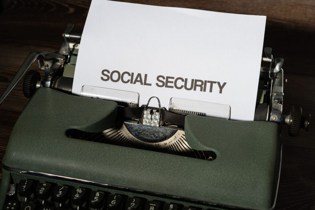 Close-up of a vintage typewriter typing 'SOCIAL SECURITY' on paper, classic concept.