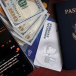 Stock trading concepts with passport, credit cards, cash, and smartphone app image.