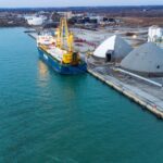 Aerial view of a cargo ship docked at the industrial Port of Oshawa, Canada.