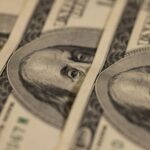 Detailed macro shot of multiple US dollar bills showcasing intricate currency design.