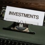 Close-up of a vintage typewriter with a paper labeled 'INVESTMENTS'.