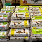 Variety of egg cartons displayed in a Melbourne store, showing organic and extra-large options.