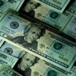 Close-up of multiple US twenty dollar bills depicting wealth and finance.