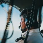 Pilot navigating helicopter over Rio de Janeiro, Brazil with scenic aerial views.