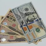 Close-up image of US dollars and Japanese yen notes, representing currency exchange concept.